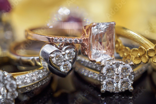 Luxury gold Jewelry diamond and pink topaz rings with reflection on black background