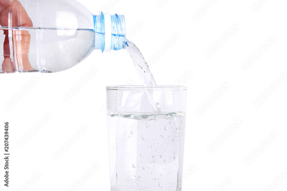 Clean drinking water from safe plastic bottles. Pouring into a glass. Clean drinking water from safe plastic bottles. Pouring into a glass.
