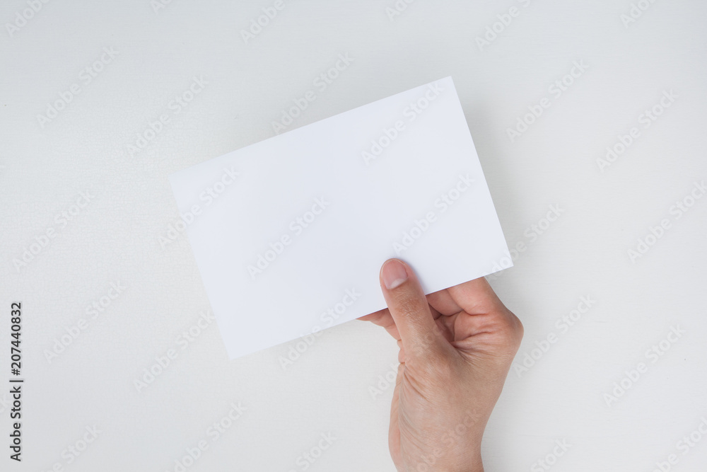 hand holding blank white paper