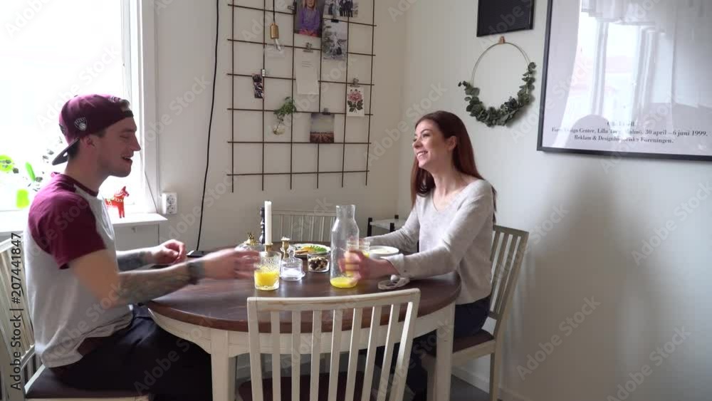 Two friends talking and laughing over breakfast Two friends talking and laughing over breakfast