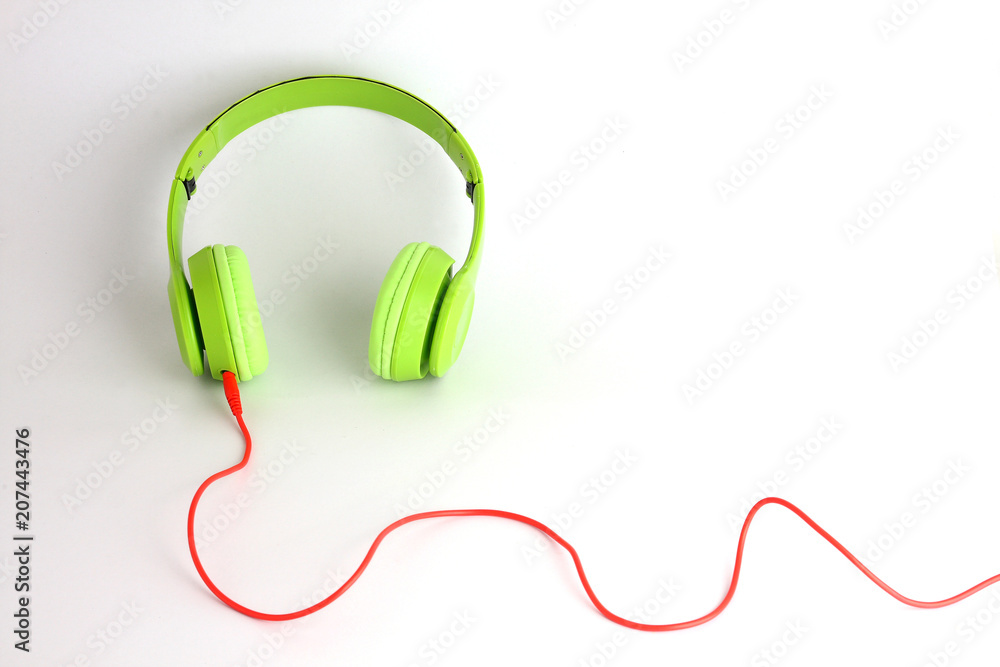 Green headphones with red acoustics. Put on white floor Green headphones with red acoustics. Put on white floor