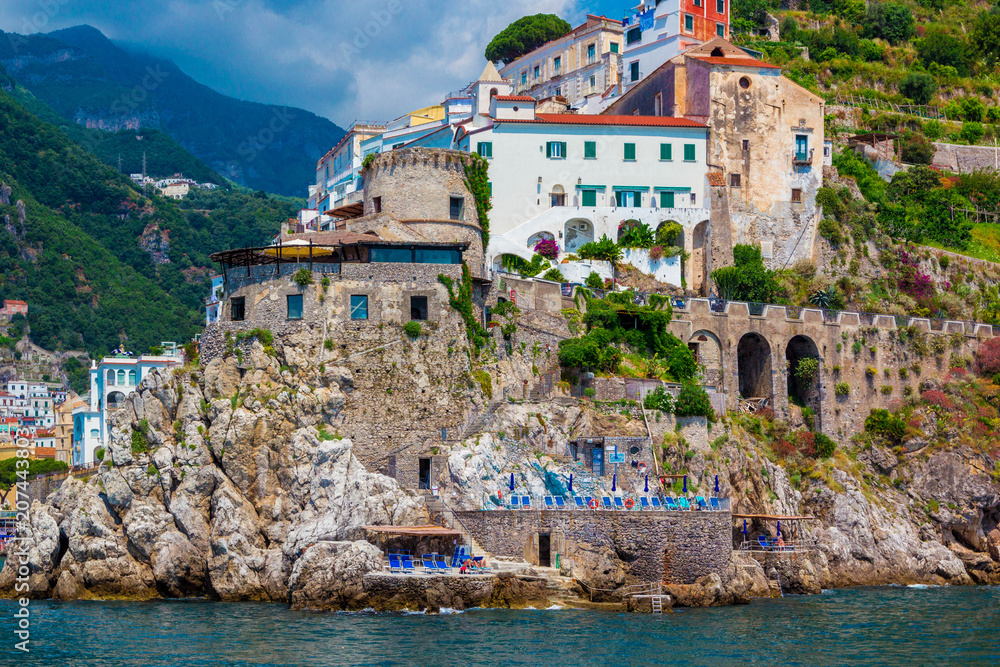 Wonderful Italy. Small town of Amalfi village with turquoise sea and colorful houses on slopes of Amalfi Coast with Gulf of Salerno, Campania, Italy.