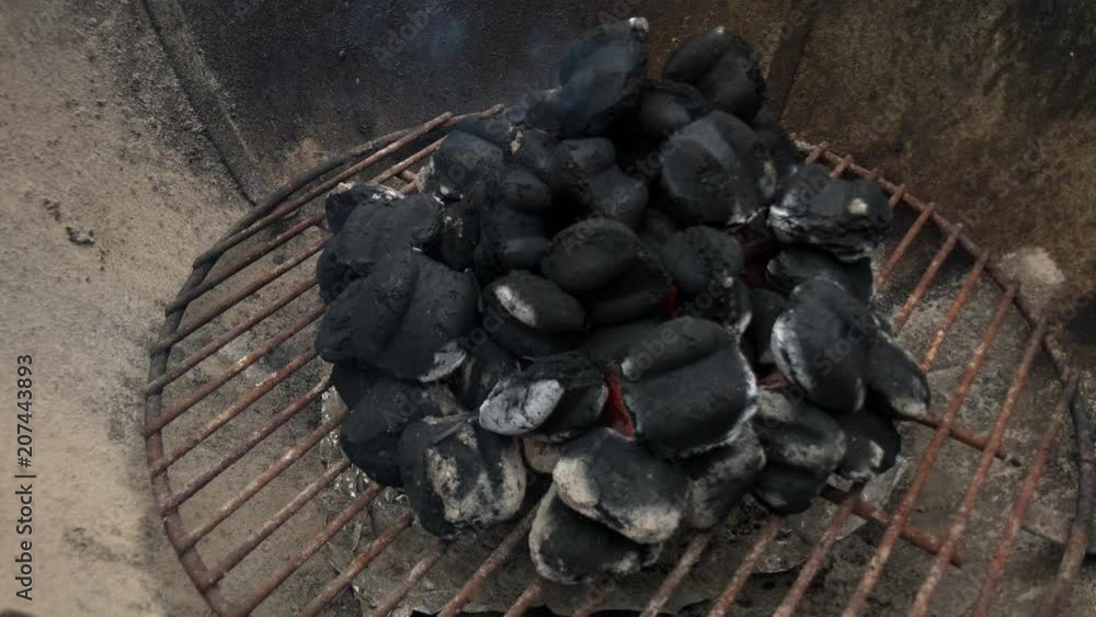 Outdoor grill as coals heat up with flames before cooking hot dogs and hamburgers. Outdoor grill as coals heat up with flames before cooking hot dogs and hamburgers.