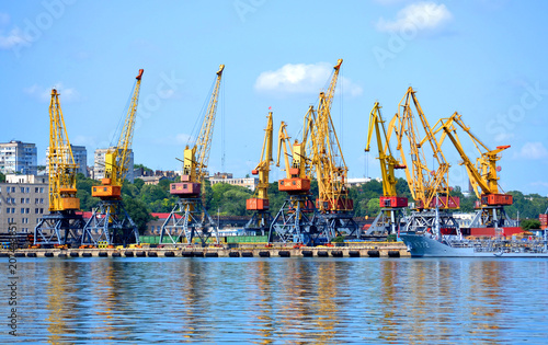 yellow cranes for lifting cargo at the sea port. City Odessa, Ukraine 18 July 2013