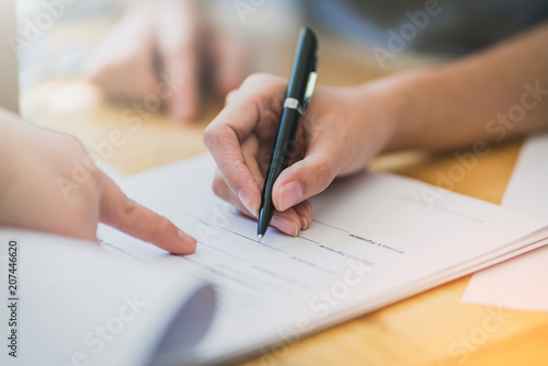success business contract deasl with sale represent and clients meeting with paper document contract and pen close up on wooden table and background