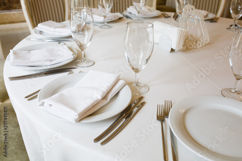 The round table is covered with a white tablecloth