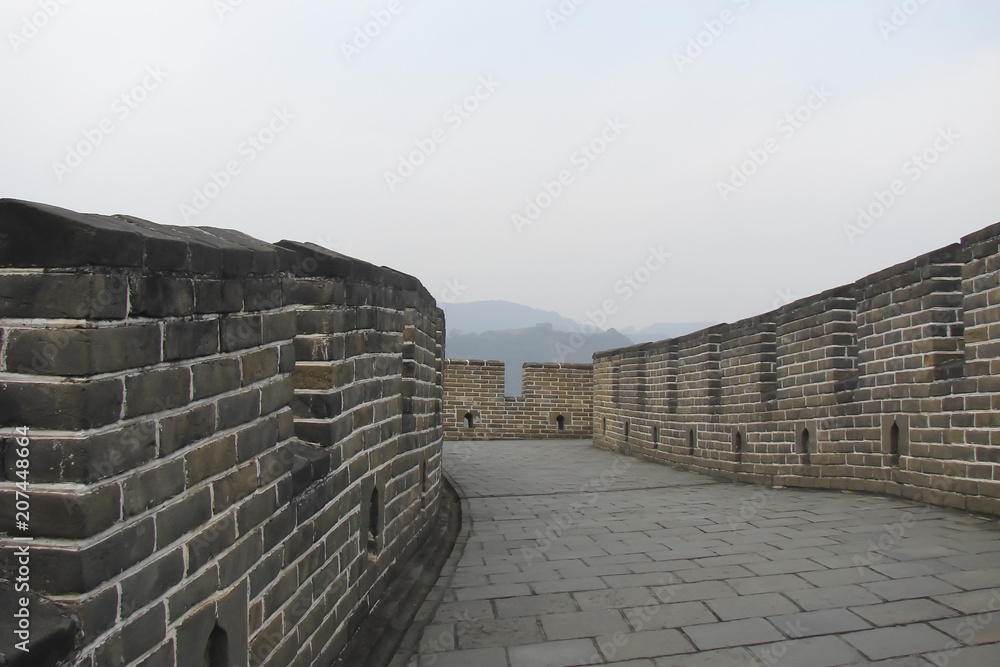the Great Wall of China; paved road, gray brick wall