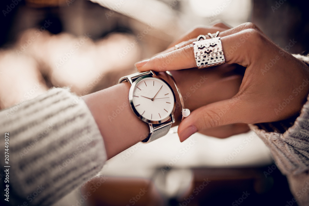 Silver watch on woman hand - obrazy, fototapety, plakaty 