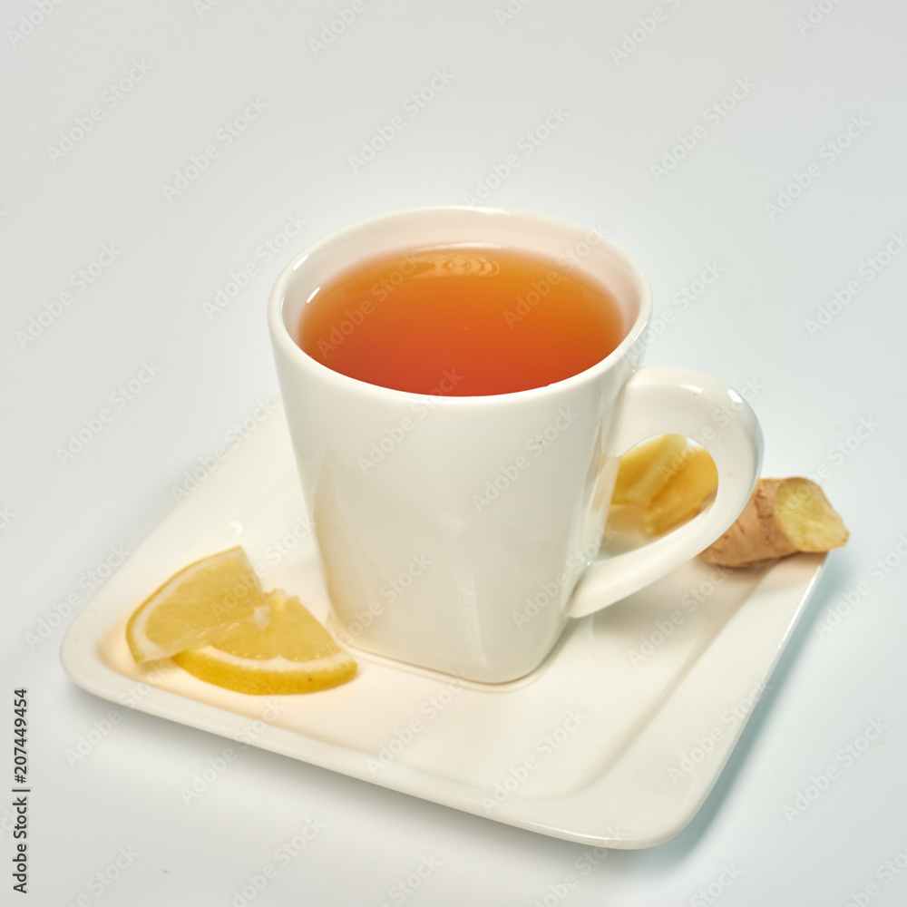 Tea with lemon and ginger./Tea in a white cup with lemon and ginger. Isolated on white background. Tea with lemon and ginger./Tea in a white cup with lemon and ginger. Isolated on white background.