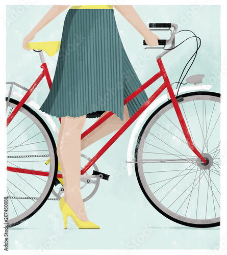 Woman on a bicycle in a summer skirt and high heels