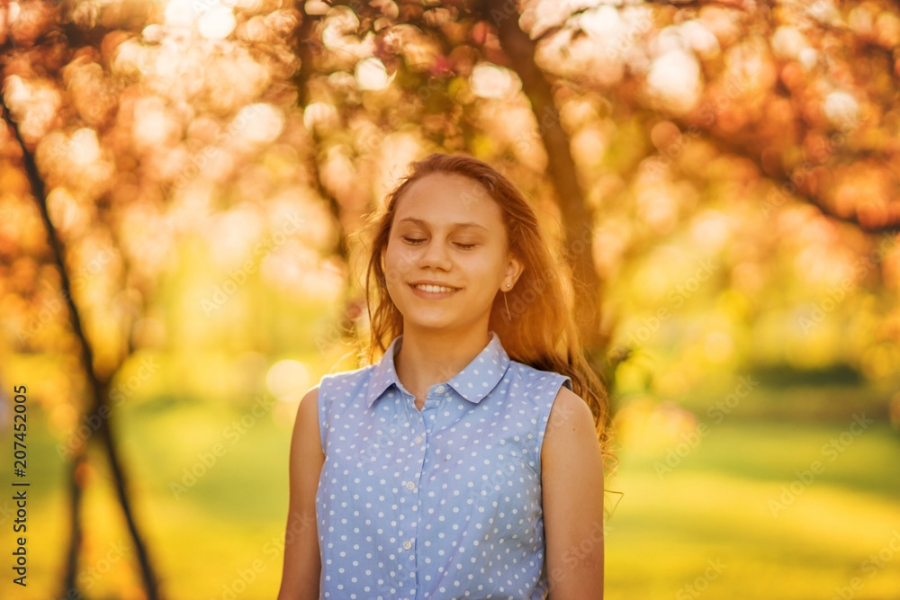 Portrait of a beautiful smiling girl with beautiful long hair in spring garden. Portrait of a beautiful smiling girl with beautiful long hair in spring garden.