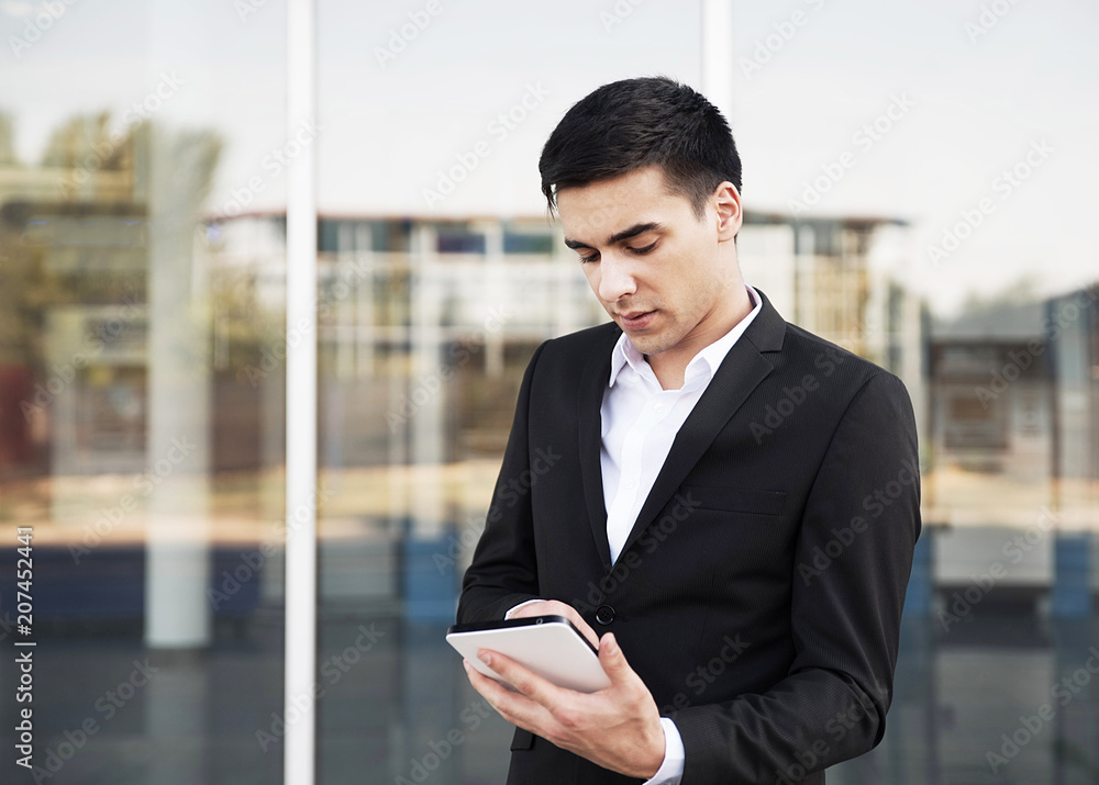 Young businessman working on tablet Young businessman working on tablet