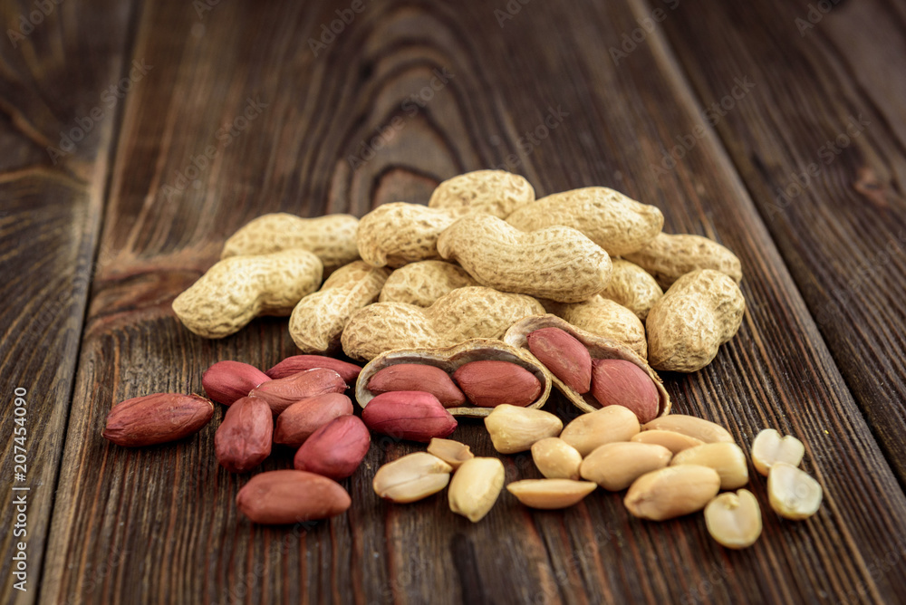 Peanut on dark wooden background. Peanut on dark wooden background.
