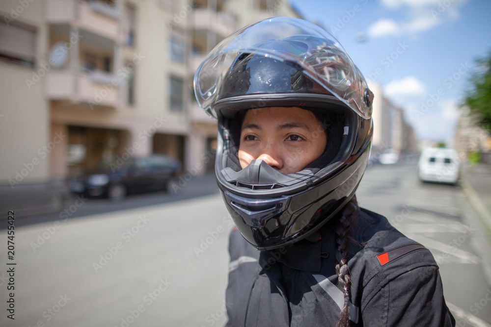 Woman with a black helmet on a motorbike