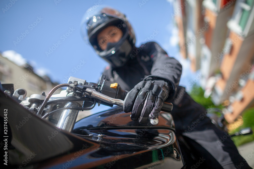 Woman with a black helmet on a motorbike Woman with a black helmet on a motorbike