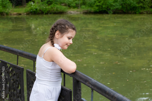 a girl admiring the pond