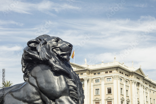 Detail of statue of a king lion, which belongs to Christopher Columbus monument. It is located in Plaza del Portal de la Pau in Barcelona, Spain. Columbus discovered America in 1492. photo