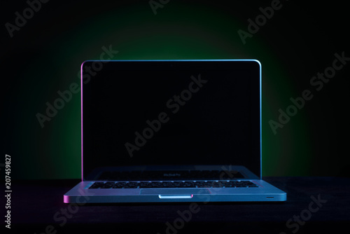 Portable modern silver computer on a black background.