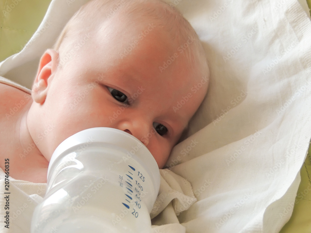 baby sucks a bottle, close-up baby sucks a bottle, close-up