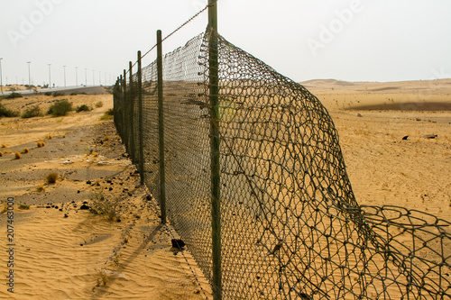 Broken Wire fence in the desert - Al Dhaid, Al Manama, Fujairah, UAE photo