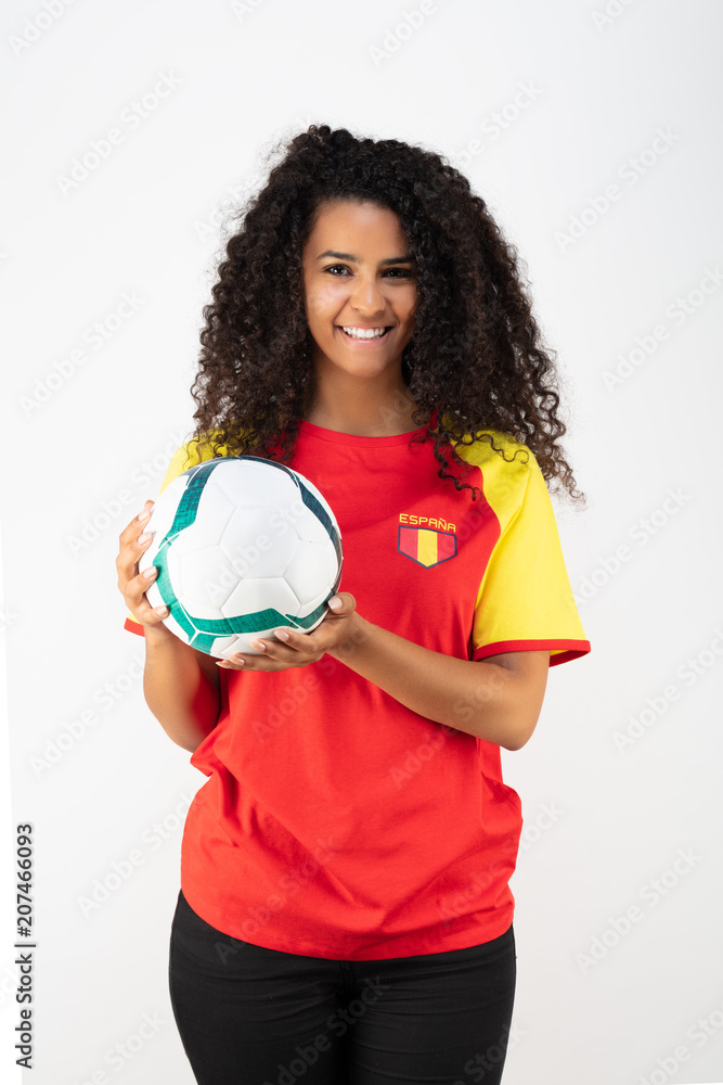 Portrait d'une jeune supportrice de l'équipe d'Espagne un ballon dans ses mains Portrait d'une jeune supportrice de l'équipe d'Espagne un ballon dans ses mains