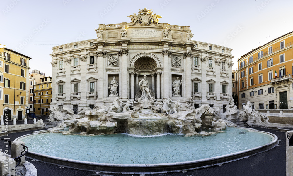 Trevi fountain at sunrise, Rome, Italy. Rome baroque architecture and landmark. Rome Trevi fountain is one of the main attractions of Rome and Italy. Panorama. Panoramic view