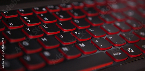 keyboard texture pattern macro. Closeup of laptop keyboard illumination, backlit keyboard