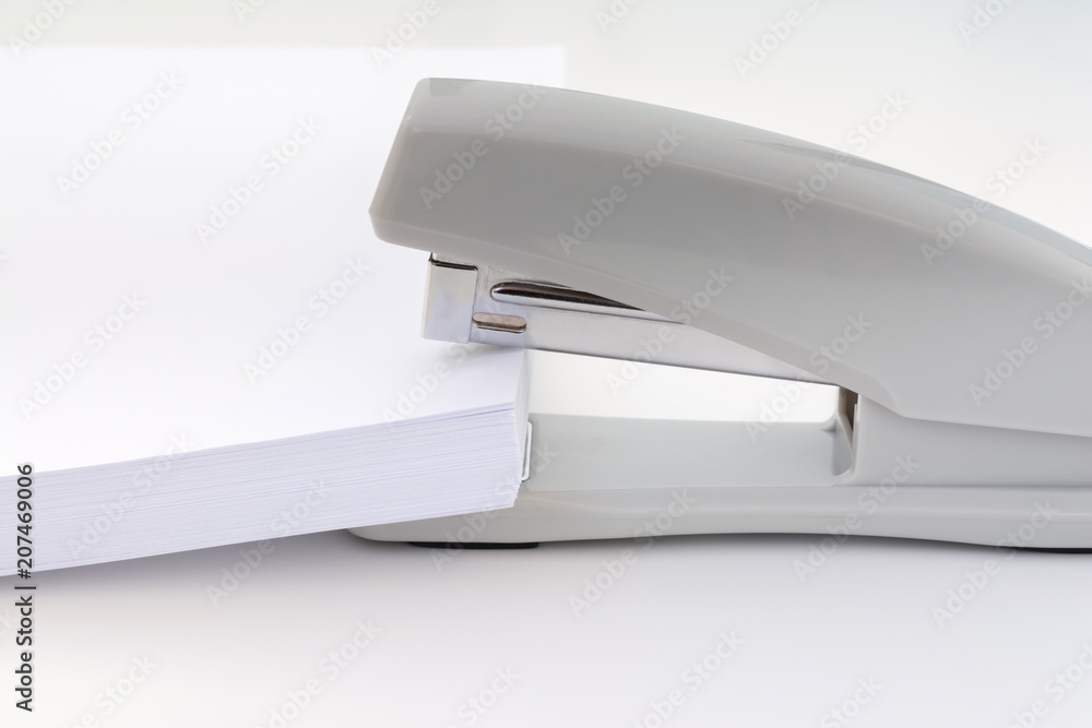 large pile of white paper is placed in a small office stapler, concept abstract background large pile of white paper is placed in a small office stapler, concept abstract background