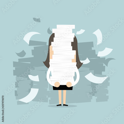 Businesswoman holding a lot of documents in her hands.