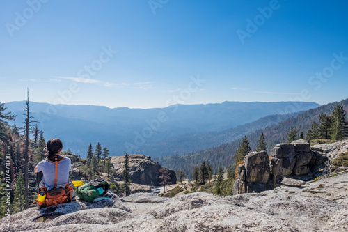 Vászonkép Taking in the views - sitting female hiker with fanny pack