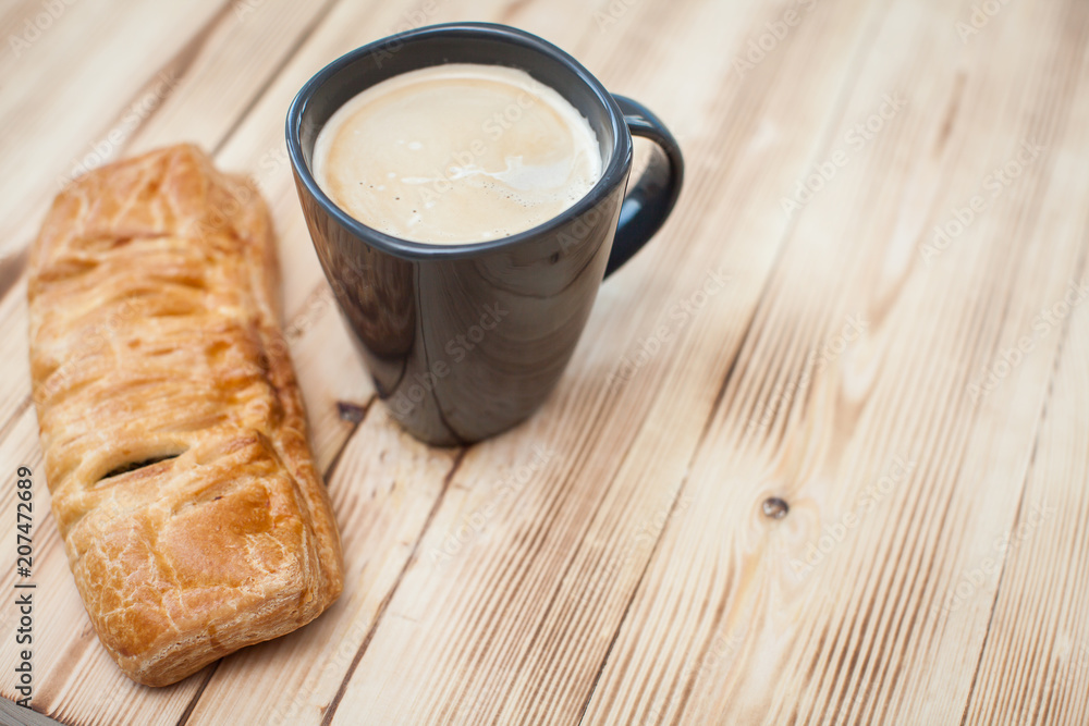 Coffee break in the country with cup of freshly brewed coffee with milk and croissan on wooden table top with copyspace Coffee break in the country with cup of freshly brewed coffee with milk and croissan on wooden table top with copyspace