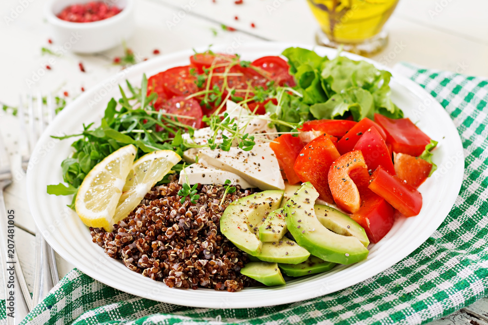 Vegetarian Buddha bowl with quinoa, tofu cheese and fresh vegetables. Healthy food concept. Vegan salad. Vegetarian Buddha bowl with quinoa, tofu cheese and fresh vegetables. Healthy food concept. Vegan salad.