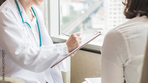 Fotografija Doctor (gynecologist or psychiatrist) consulting and examining woman patient's h