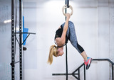 woman working out on gymnastic rings
