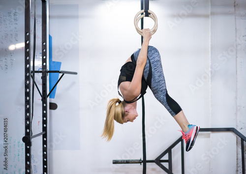 woman working out on gymnastic rings