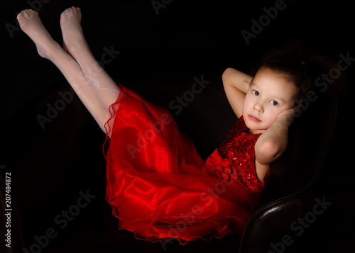 Little girl on a black background
