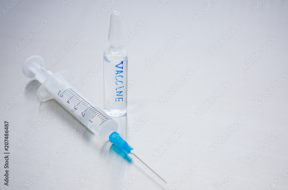 Close-up of the vaccine in a sealed vial. Kit for vaccination. Close-up of the vaccine in a sealed vial. Kit for vaccination.