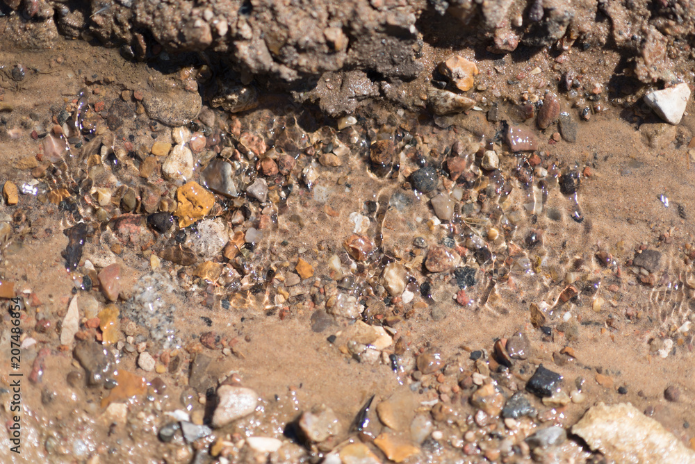 brown natural wet rocks in river water background brown natural wet rocks in river water background