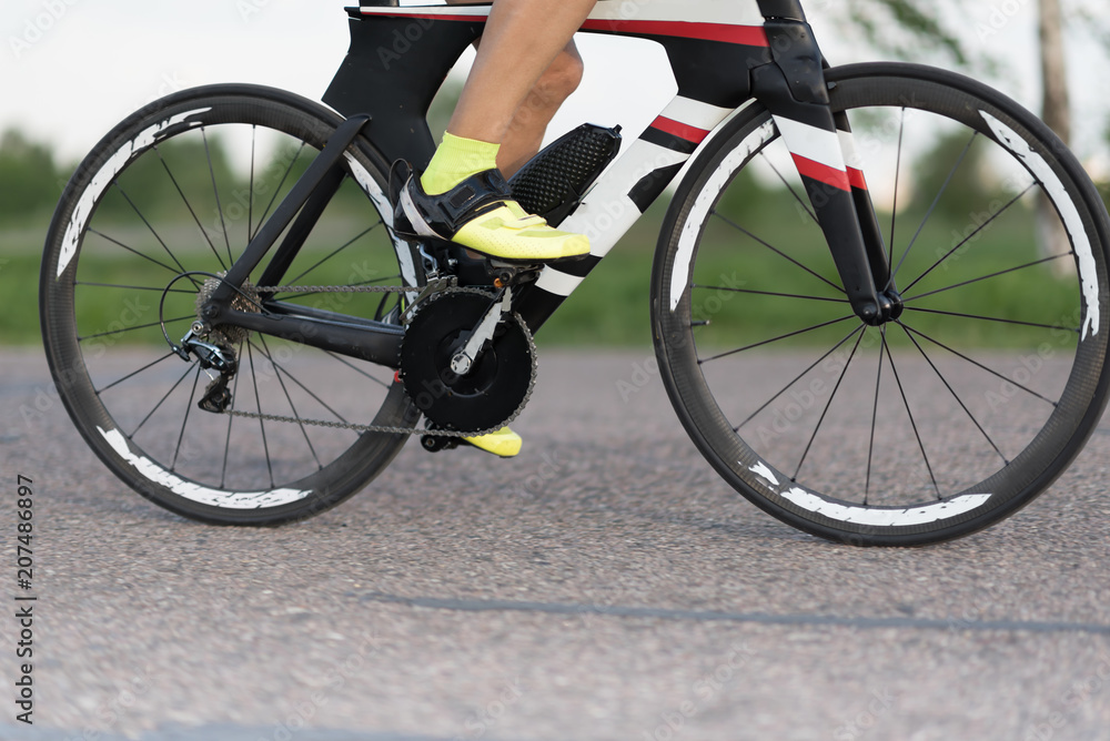 Cyclist in maximum effort in an asphalt road outdoors Cyclist in maximum effort in an asphalt road outdoors