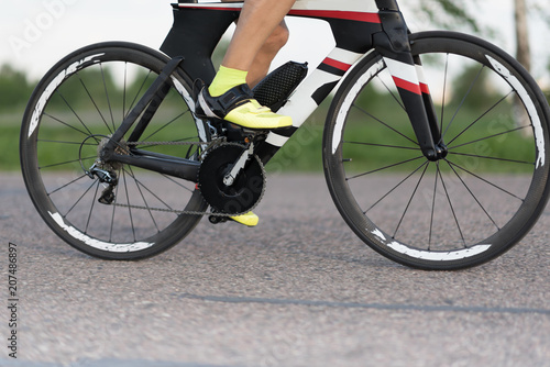 Cyclist in maximum effort in an asphalt road outdoors