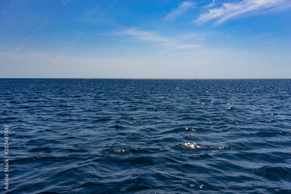The water surface of the sea with small waves.
