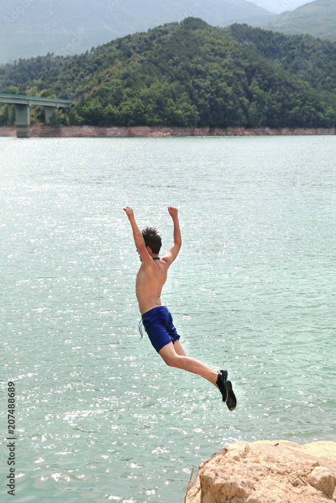 Boy jumping into the water 