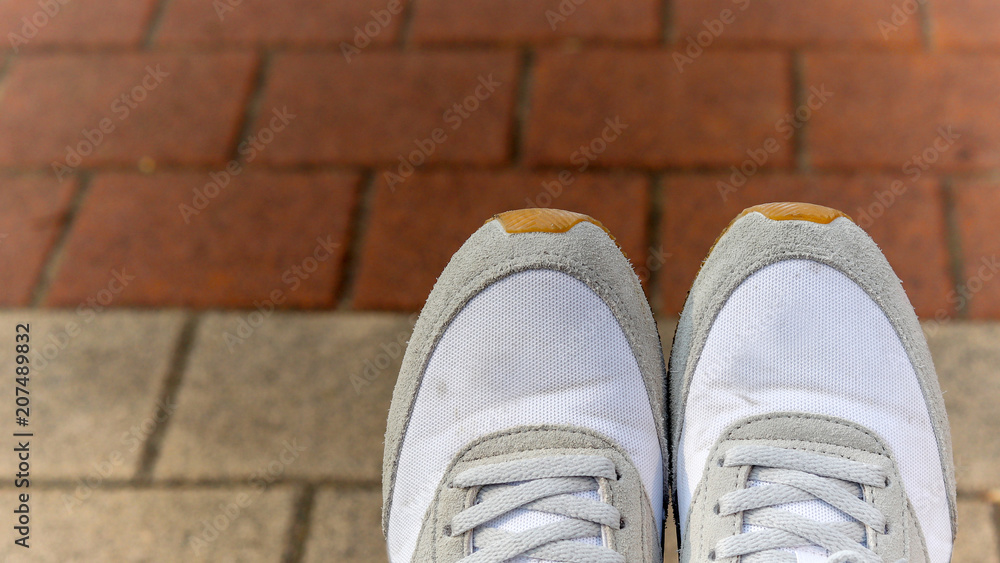 Close-up images of shoes in the street.