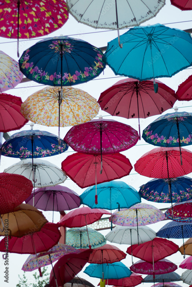 Colorful roof of rainbow umbrellas in the street