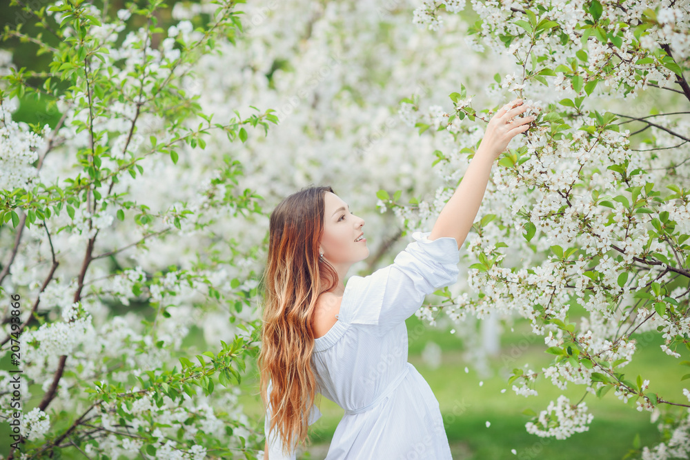 Close up romantic portrait of beautiful elegant woman in blossom spring trees. Close up romantic portrait of beautiful elegant woman in blossom spring trees.