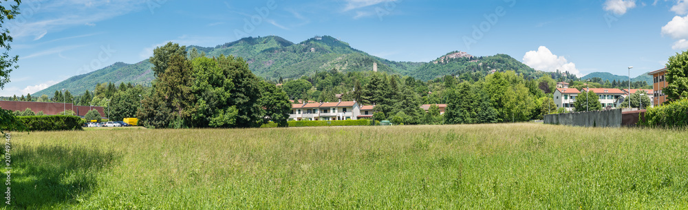 Varese, Italy. Panoramic view towards the mountain behind the city, Campo dei Fiori (regional park) and the small village of Sacro Monte (UNESCO site); in the middle the remains of the Torre di Velate Varese, Italy. Panoramic view towards the mountain behind the city, Campo dei Fiori (regional park) and the small village of Sacro Monte (UNESCO site); in the middle the remains of the Torre di Velate