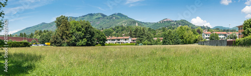 Varese, Italy. Panoramic view towards the mountain behind the city, Campo dei Fiori (regional park) and the small village of Sacro Monte (UNESCO site); in the middle the remains of the Torre di Velate