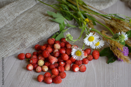 wild strawberries and flowers on the table