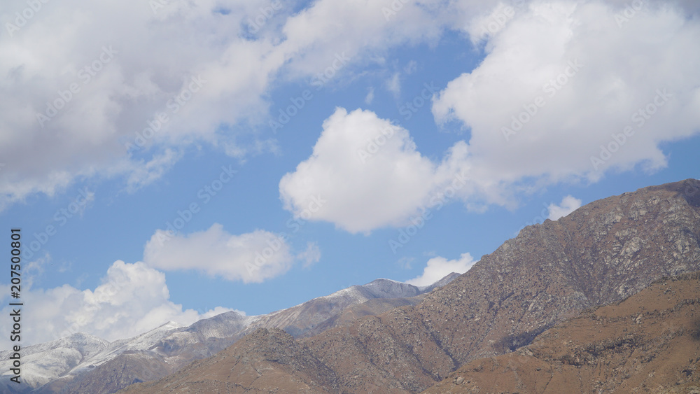 Fototapeta premium Mountain peak with some clouds and clear blue sky