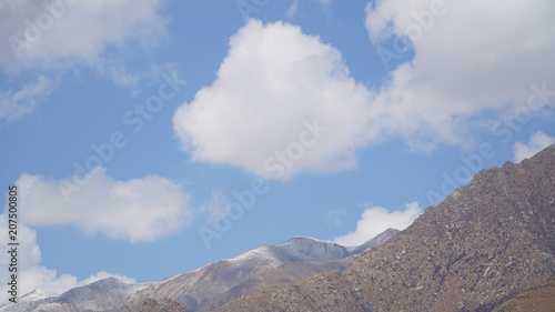 Fototapeta Naklejka Na Ścianę i Meble -  Mountain peak with some clouds and clear blue sky